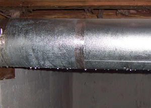 condensation collecting on an HVAC vent in a humid Dillon basement